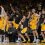 The Iowa bench stands and celebrates a three-pointer
