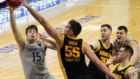 Luka Garza blocks a shot and everyone makes faces
