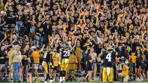 Matt Hankins and Jack Koerner celebrate with fans at Kinnick Stadium