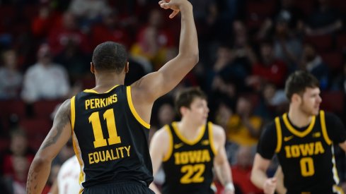 Iowa Hawkeyes guard Tony Perkins reacts after a three point basket