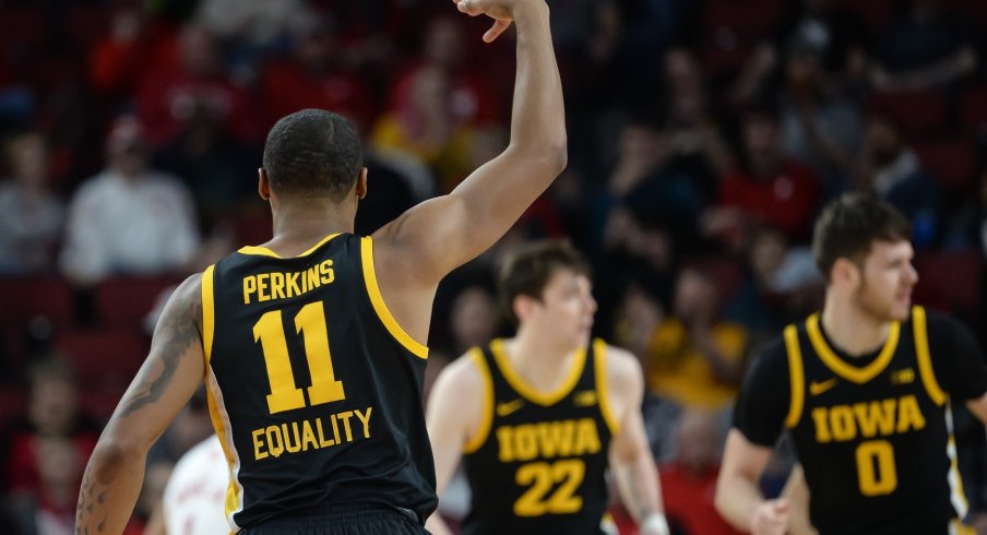 Iowa Hawkeyes guard Tony Perkins reacts after a three point basket