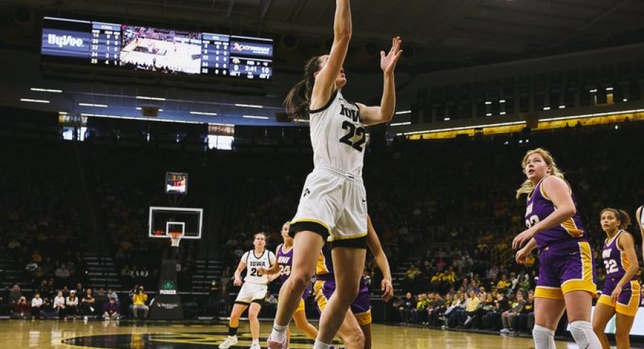 Caitlin Clark scores a layup against UNI